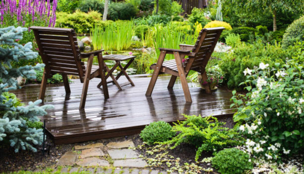 Garden chairs near the pond in a beautiful garden