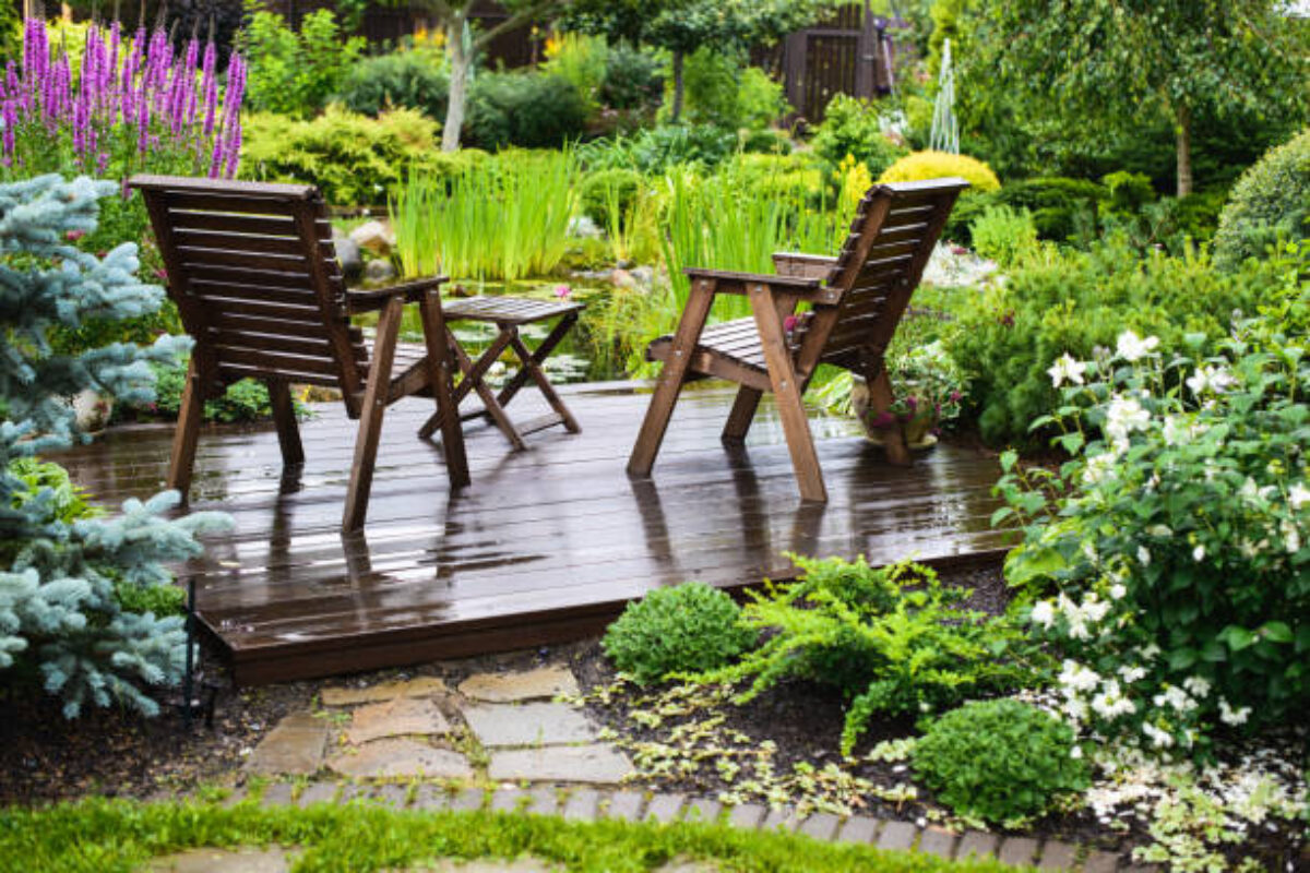 Garden chairs near the pond in a beautiful garden