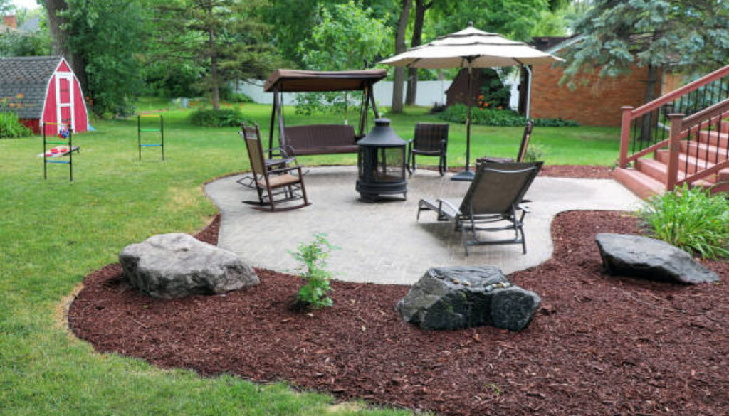 Man mulching yard in suburban house