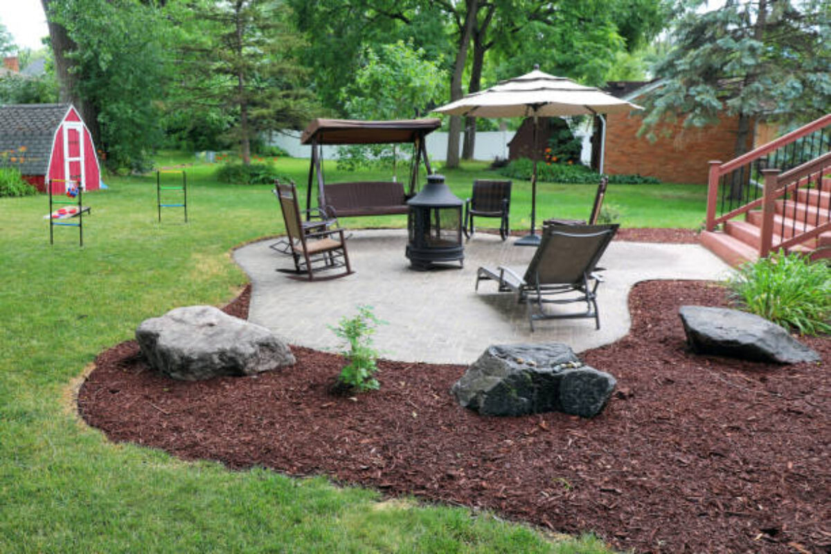 Man mulching yard in suburban house
