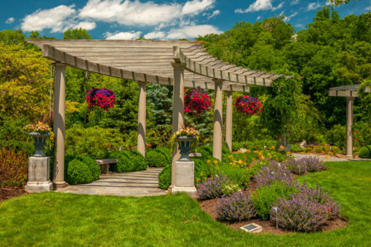 Beautiful view of a lush summer gardens with hanging baskets.