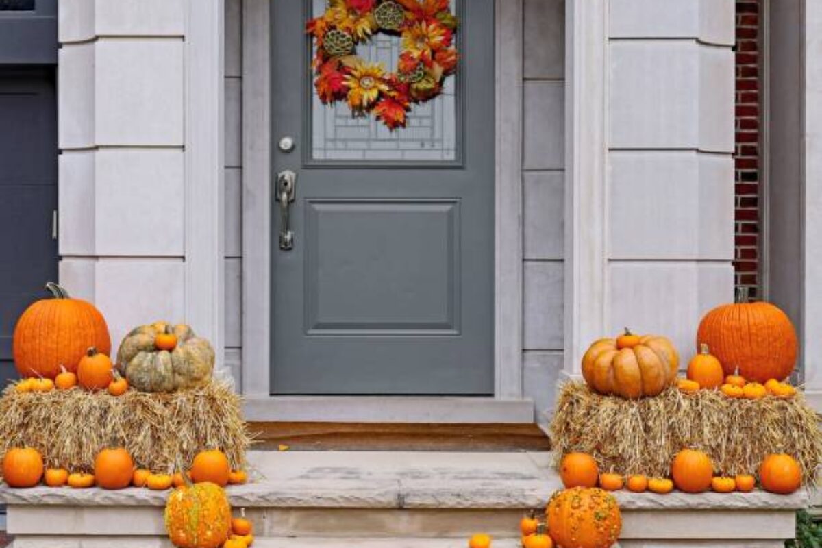Front steps of house with pumpkins and fall decorations